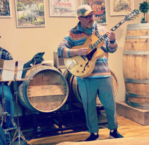 Jeremiah Williams playing an archtop guitar during a jazz jam