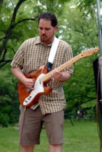 Jeremiah Williams playing electric guitar outdoors